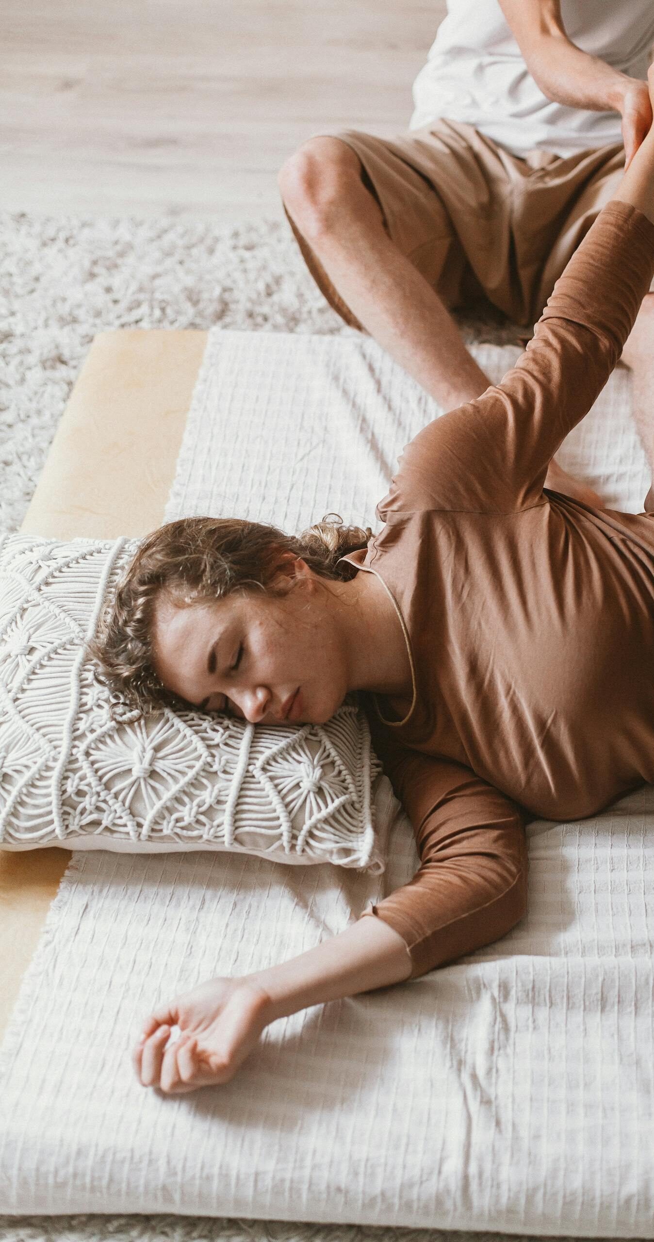 Young woman receiving relaxing manual therapy at home for stress relief.